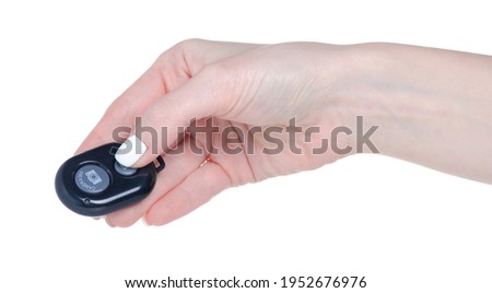 Shutter release button remote control for the camera in hand on white background isolation