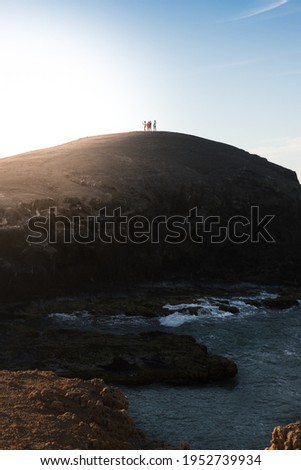 A group of people stand on top of a hill at Cabo de la Vela, Guajira. Colombia