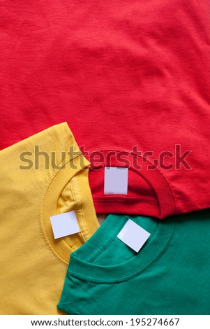 Three bright t-shirts. Clean labels,  creative background