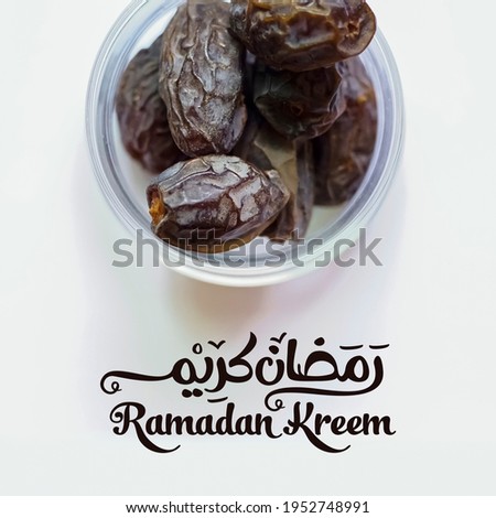 Dried date fruit in the plate with Ramadan Kareem typography.