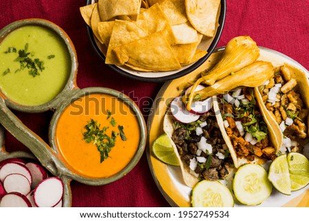 Plates of Appetizers including chips, salsa, and tacos are presented from a Mexican Restaurant