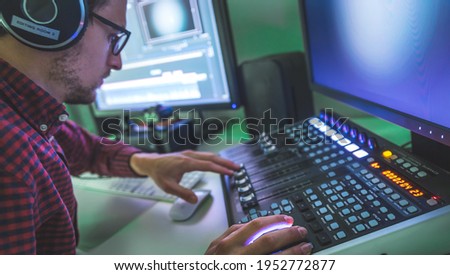 Video editing, recording and cutting room with monitors and sound mixing desk Royalty-Free Stock Photo #1952772877