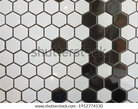 Small white hexagonal tile inserted with a little black color.