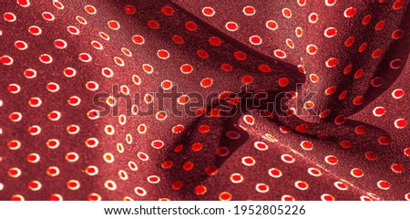 red silk fabric with red polka dots. Light and silky-soft satin pendant is perfect for your design, online projects. Texture background, pattern, 