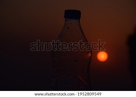 Beautiful picture of water bottle. Sunset in background