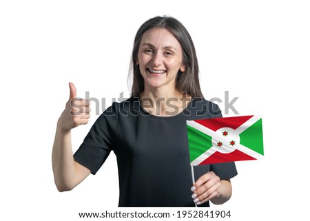 Happy young white woman holding flag of Burundi and shows the class by hand isolated on a white background.
