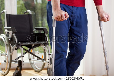 Horizontal view of a disabled man on crutches Royalty-Free Stock Photo #195284591