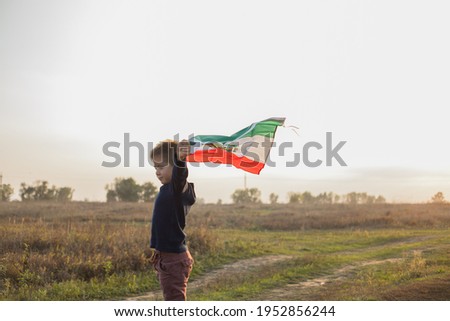 Young boy holding flag of Mexico. "September 16. Independence Day of Mexico".