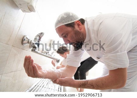 a group of Muslims take ablution for prayer. Islamic religious rite Royalty-Free Stock Photo #1952906713
