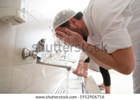 a group of Muslims take ablution for prayer. Islamic religious rite Royalty-Free Stock Photo #1952906716