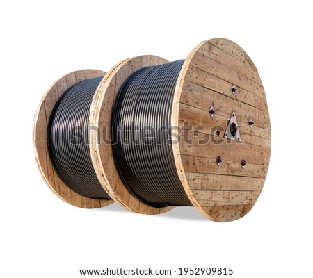 Wooden Coils Of Electric wire Outdoor. High and low voltage cables on white background. Large cable for electrical work. Royalty-Free Stock Photo #1952909815