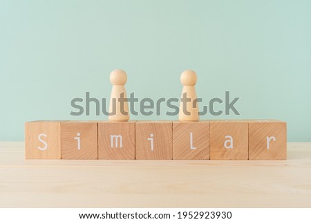 Similar; Seven wooden blocks with  "Similar" text of concept and two human toys. Royalty-Free Stock Photo #1952923930