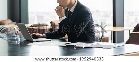 Young Japanese businessman working indoors Royalty-Free Stock Photo #1952940535