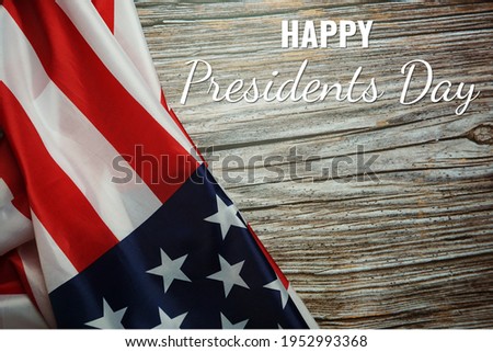 Happy Presidents' Day text on wooden with flag of the United States Border