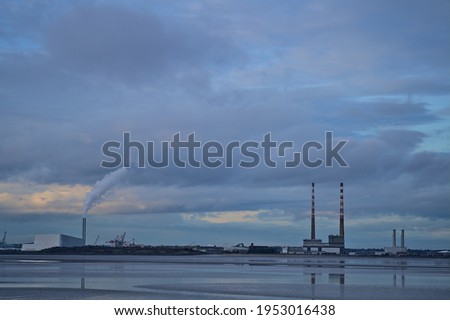 Dublin Waste to Energy (Covanta Plant), Poolbeg CCGT and Pigeon House Power Station view from Blackrock Beach, Dublin, Ireland. Beautiful evening view with reflection in the water