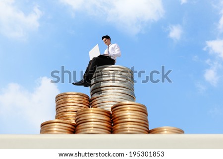 Successful business man working on growth money stairs coin with sky