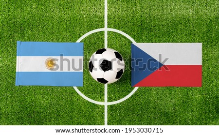 Top view ball with Argentina vs. Czech republic flags match on green soccer field.
