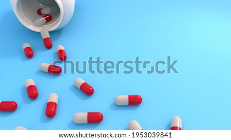 Prescription medication, pharmaceutical treatment and pain management concept with white red pills capsules isolated on blue background with bottle