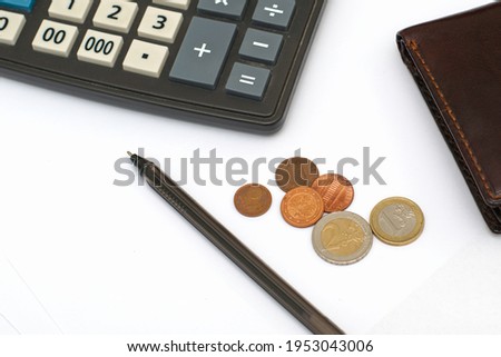 small coins wallet calculator and fountain pen on sheets of white paper on the table concept business budget economy. High quality photo