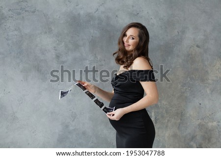Happy pregnant woman with ultrasound scan image portrait