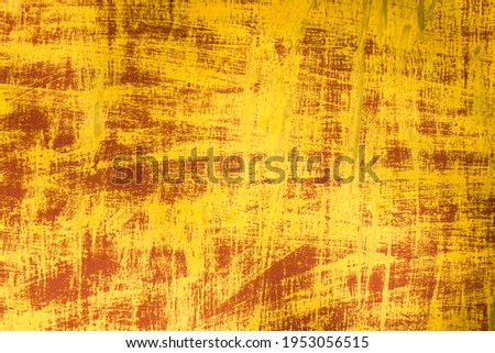 Abstract paint texture. Yellow paint lines on a red background. Scrapbooking underlay.