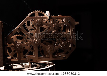 Wooden gears of the mechanism close-up on a black background