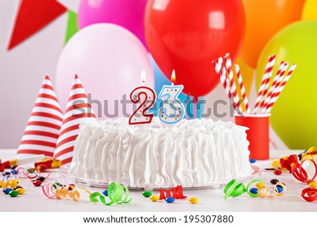Birthday Cake On Colorful Balloon Background With Other Birthday Decoration. Focus is on cake.