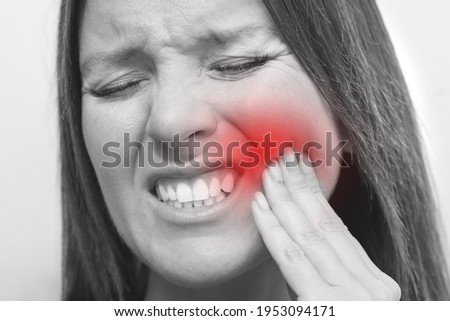 Close up of woman face with tooth pain and painful expression. Woman suffering from toothache. Female feeling tooth pain
