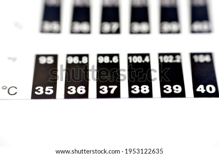 Fast Check Forehead Thermometer Strip. for Home or School. Reusable Color Change Bands Monitor Fever and Temperature of Infants, Babies, Toddlers and Kids. Quick Read in Celsius and Fahrenheit Scales Royalty-Free Stock Photo #1953122635
