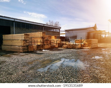 Wood warehouse. Lumber logs, boards and beams basic building material. Industrial plant sawmill - storage of wooden boards