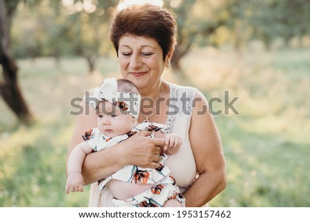 grandmother with granddaughter in the summer garden
