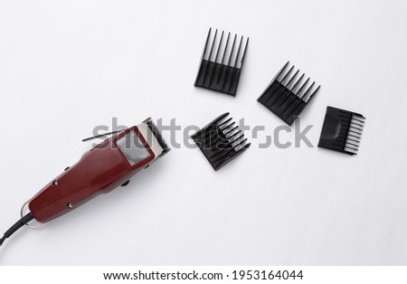 Machine for hairstyle. Barbershop. Hair clippers with nozzle isolated on white background. Royalty-Free Stock Photo #1953164044