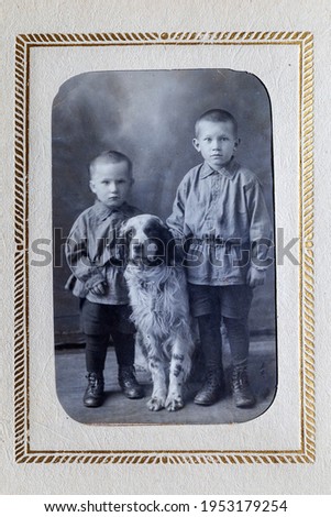 Vintage family photographs of the early 19th century, Vintage photograph of a noble Russian family, two brothers of a boy with a dog in full growth
