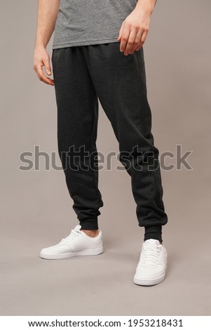 men track suit ​in front of grey background in studio Royalty-Free Stock Photo #1953218431