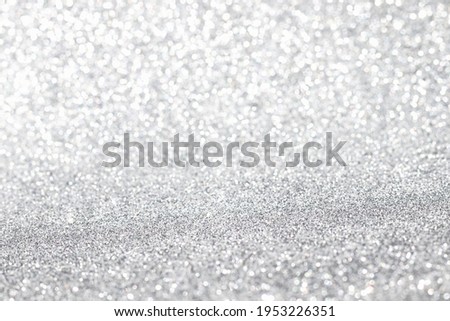 Shiny blurred white or gray background with bokeh for a festive mood. Greeting card template for fun. Blurry bokeh