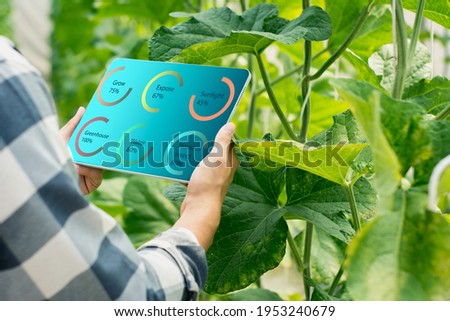 smart farmer using smart tablet,organic farm production control,concept business and agricultural technology,agriculture future trading world market,track productivity,satellite for Agriculture