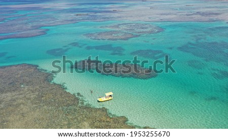 Aerial view of a yellow boat near a coral reef in Costa dos Corais near São Miguel dos Milagres, Alagoas, Brazil Royalty-Free Stock Photo #1953255670