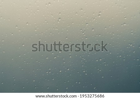 Water droplets on a yellow, blue background