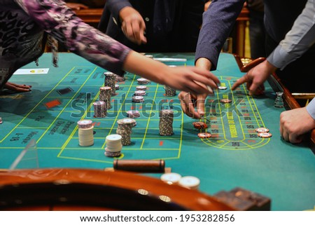 People playing poker in the casino, roulette, gambling.

