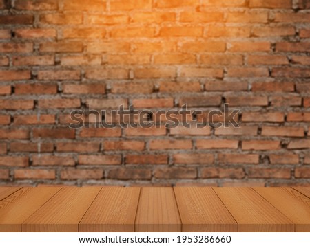 Old wood table with abstract blur brick wall with light background for product display