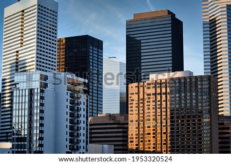 City downtown with office skyscrapers, high-rise condo apartment buildings, glass towers, blue skies, sunny outdoor city.