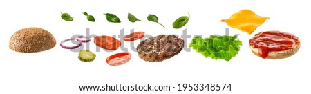 Delicious burger ingredients isolated on white background. Royalty-Free Stock Photo #1953348574