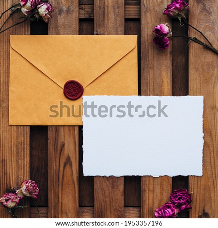 Wedding Flat lay. Wedding invitation set with card mockups for instagram. Wedding set with a yellow envelope and an invitation form on a wooden background with bush rose flowers.