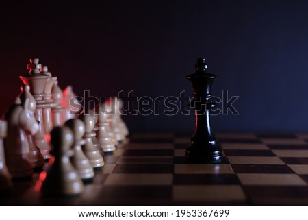 the black king is alone in front of the white pieces on a chessboard