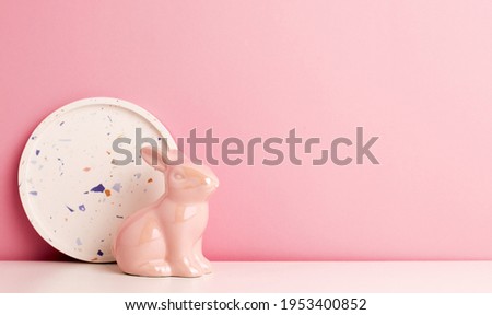 Small pink easter bunny on a pink background