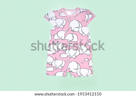 Baby clothes on color background