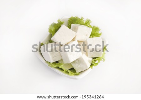 Piece of Cheese or Paneer Isolated on A White Background Royalty-Free Stock Photo #195341264