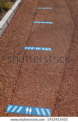Marking on street in order to guide social distancing due to coronavirus or covid-19 pandemic. Concept of the coronavirus pandemic and prevention measures. footprint sign social distance