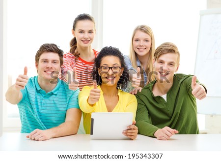 education, technology and college concept - five smiling students with tablet pc computer at school and showing thumbs up