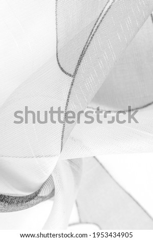 thin knitted fabric - light transparent, black and white, monochromatic geometric colors, similar to a veil made of thin viscose silk. organza pattern.